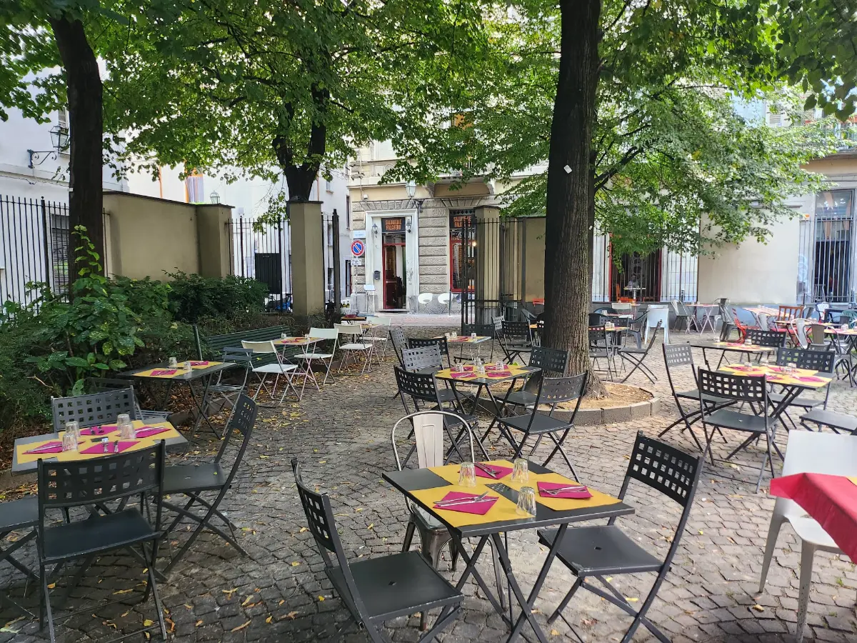 The outdoor seating in the tree-lined square